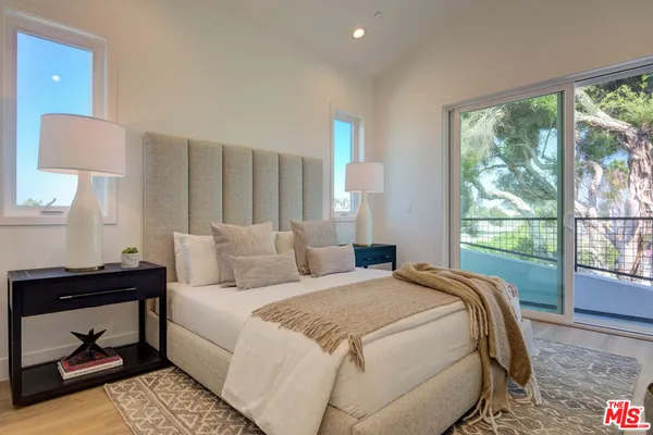a bedroom with a bed lamp and window