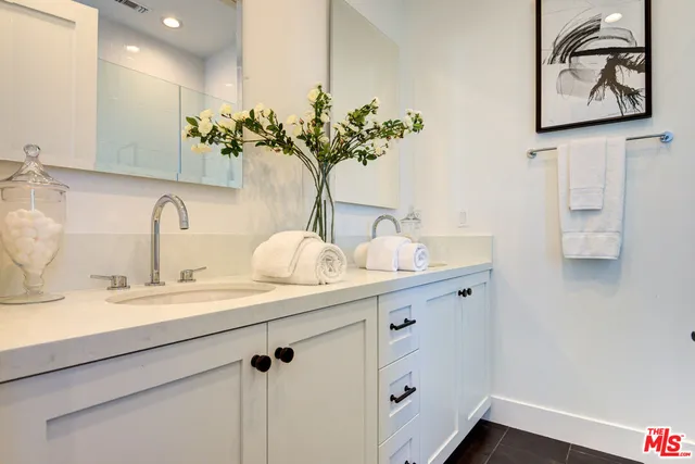 a bathroom with a sink a vanity and a mirror