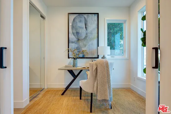 a view of a hallway with seating area