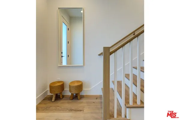a view of a hallway with chair and table
