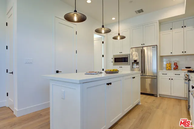 a kitchen with a refrigerator a sink and dishwasher