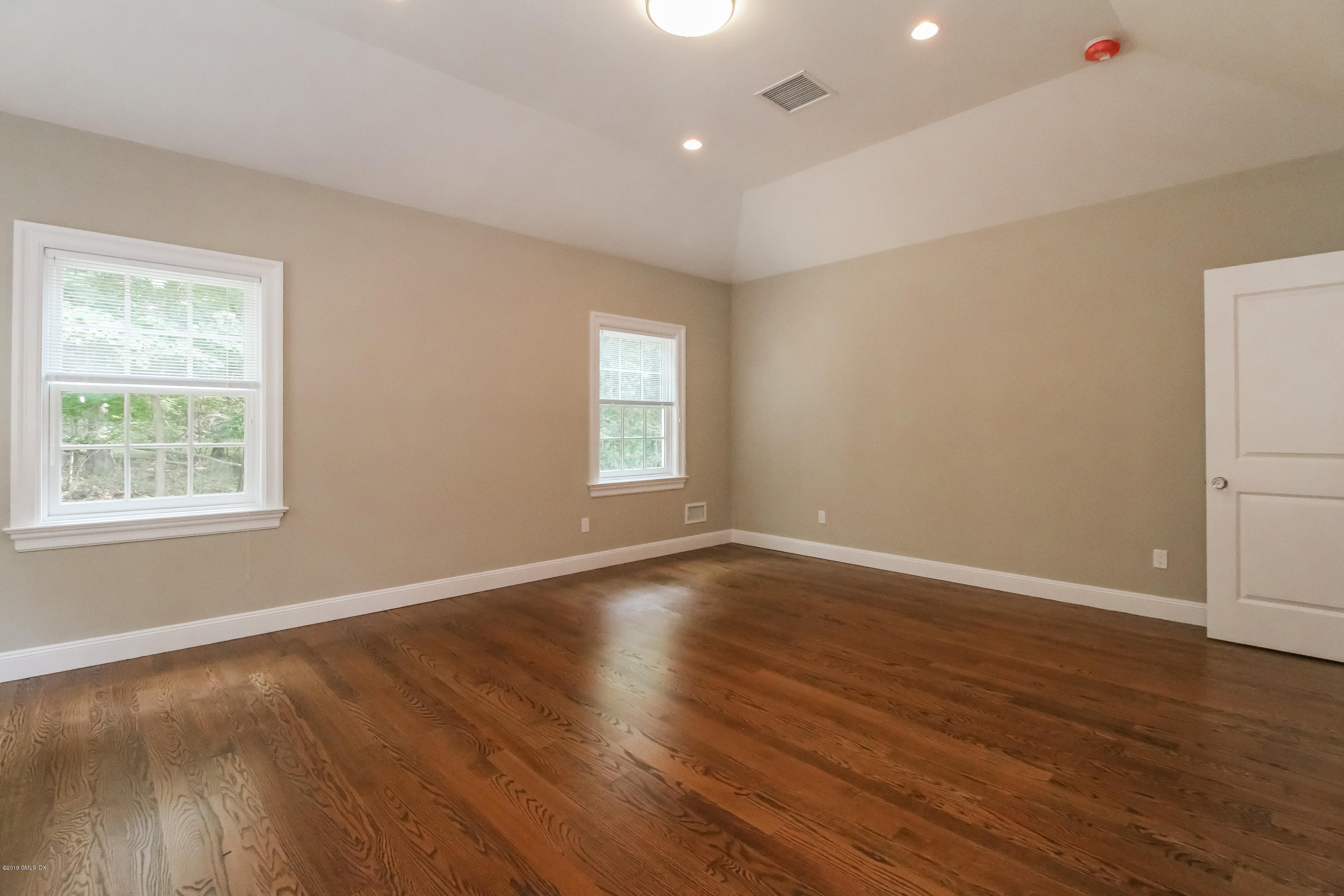 54 Dandy Drive Cos Cob, CT 06807 - Photo 12 of 35 a view of an empty room with wooden floor and a window