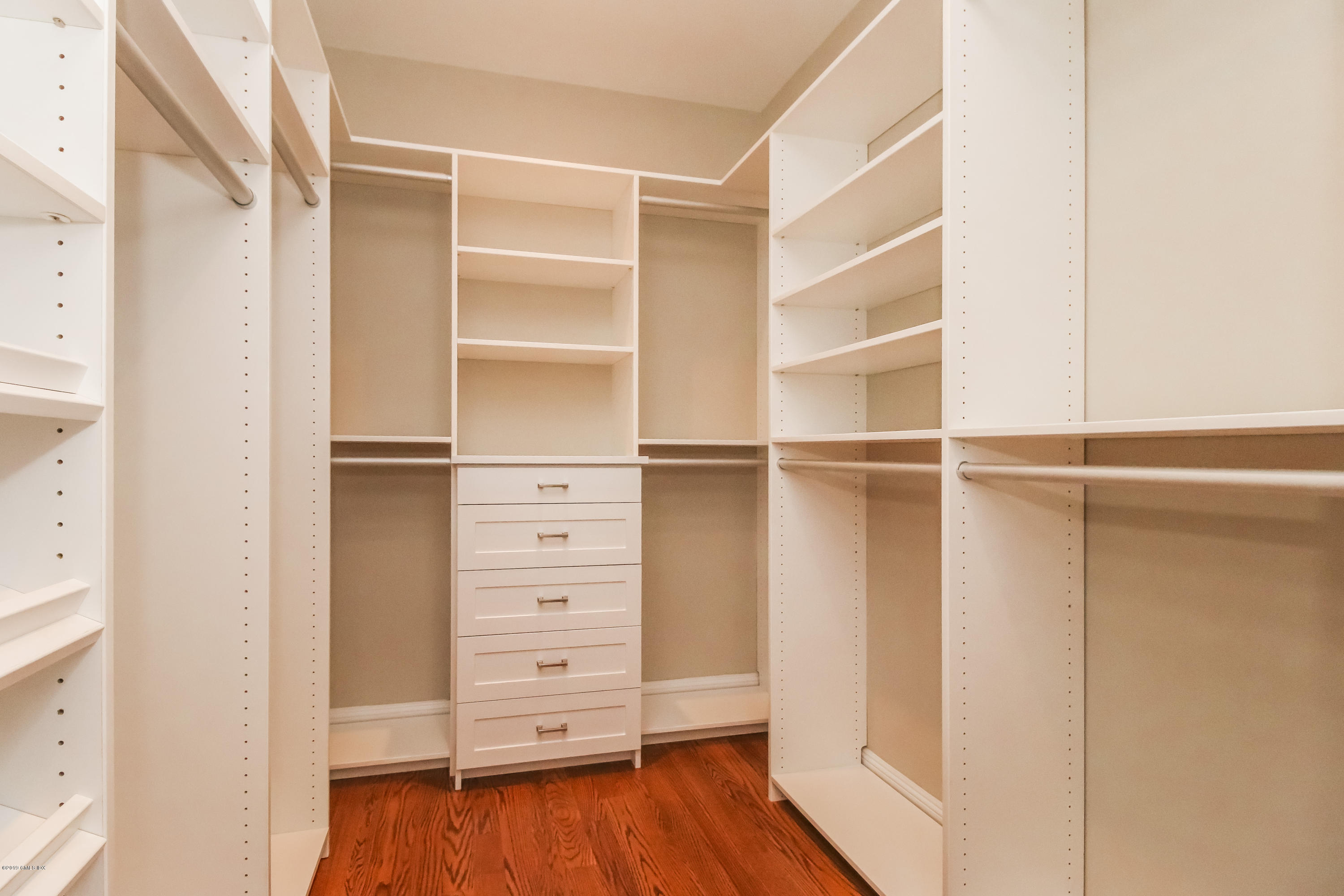 54 Dandy Drive Cos Cob, CT 06807 - Photo 14 of 35 a view of walk in closet with empty racks