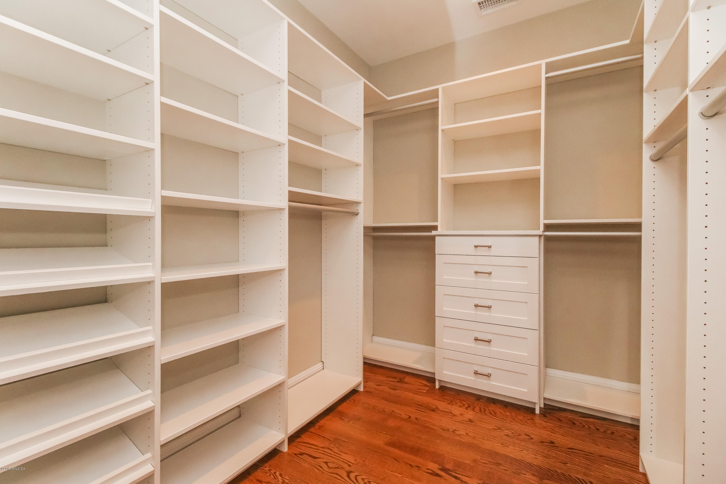 54 Dandy Drive Cos Cob, CT 06807 - Photo 15 of 35 a view of walk in closet with empty racks