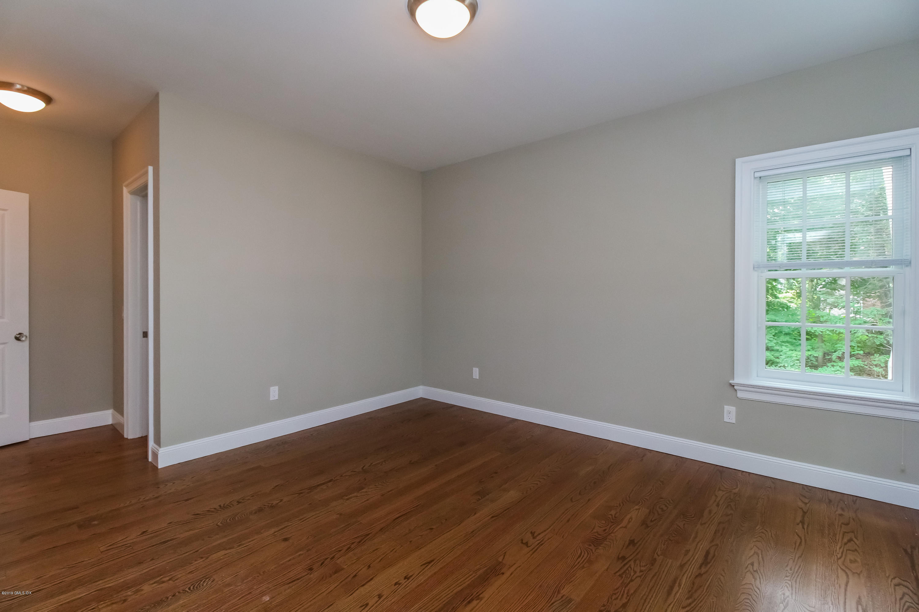 54 Dandy Drive Cos Cob, CT 06807 - Photo 20 of 35 a view of a room with wooden floor and windows