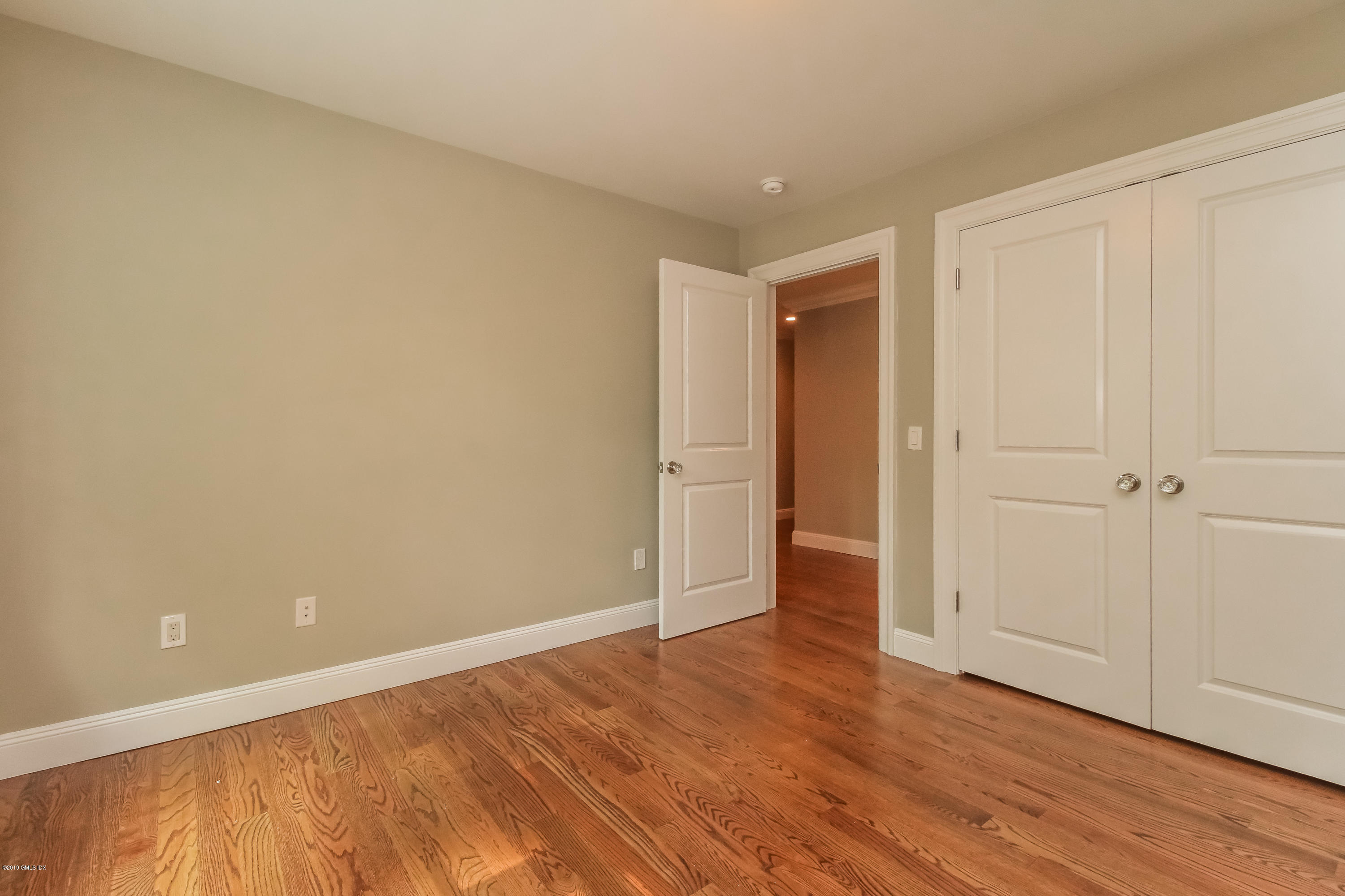 54 Dandy Drive Cos Cob, CT 06807 - Photo 23 of 35 a view of an empty room with wooden floor