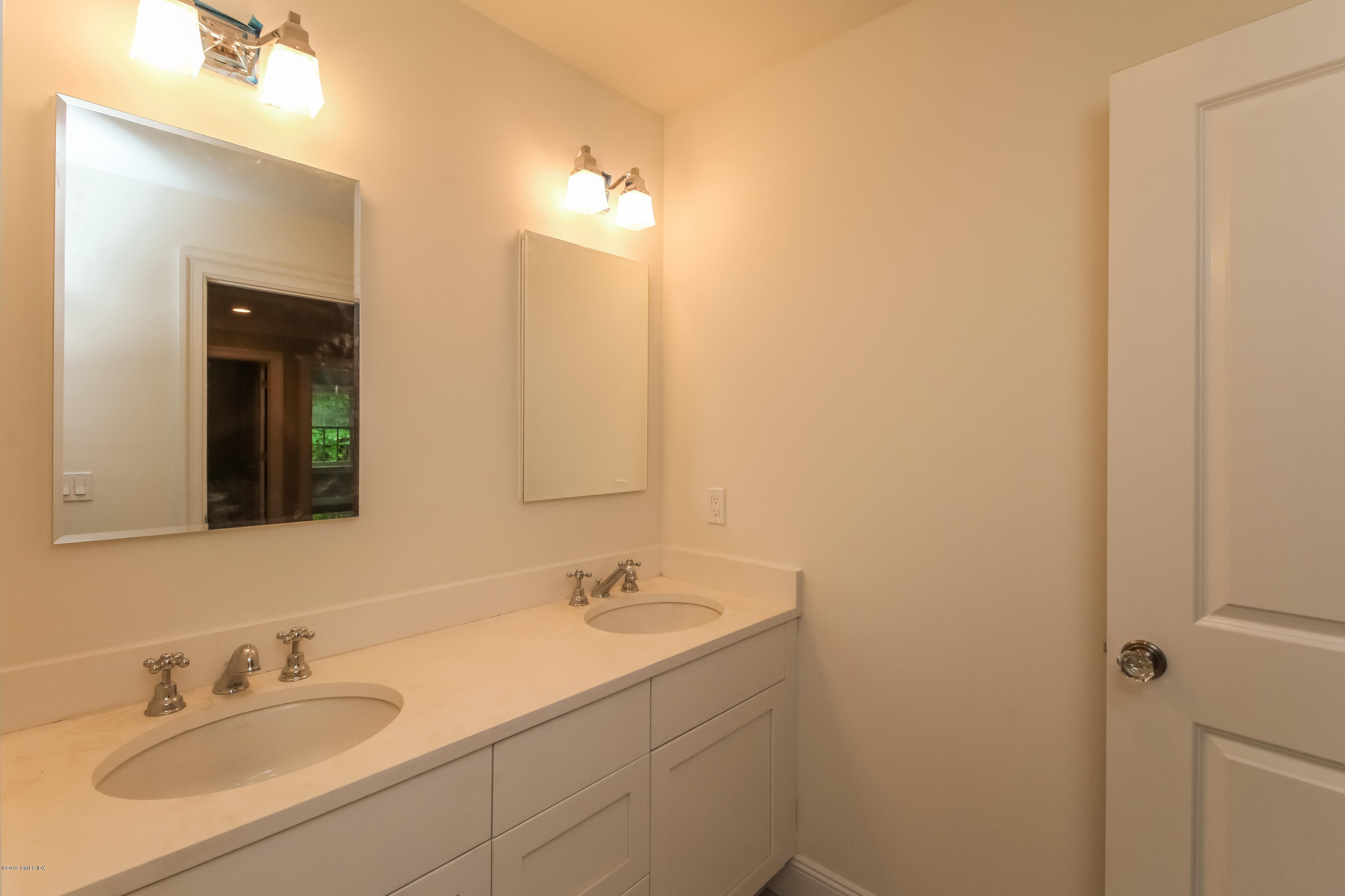 54 Dandy Drive Cos Cob, CT 06807 - Photo 24 of 35 a bathroom with a sink and a mirror