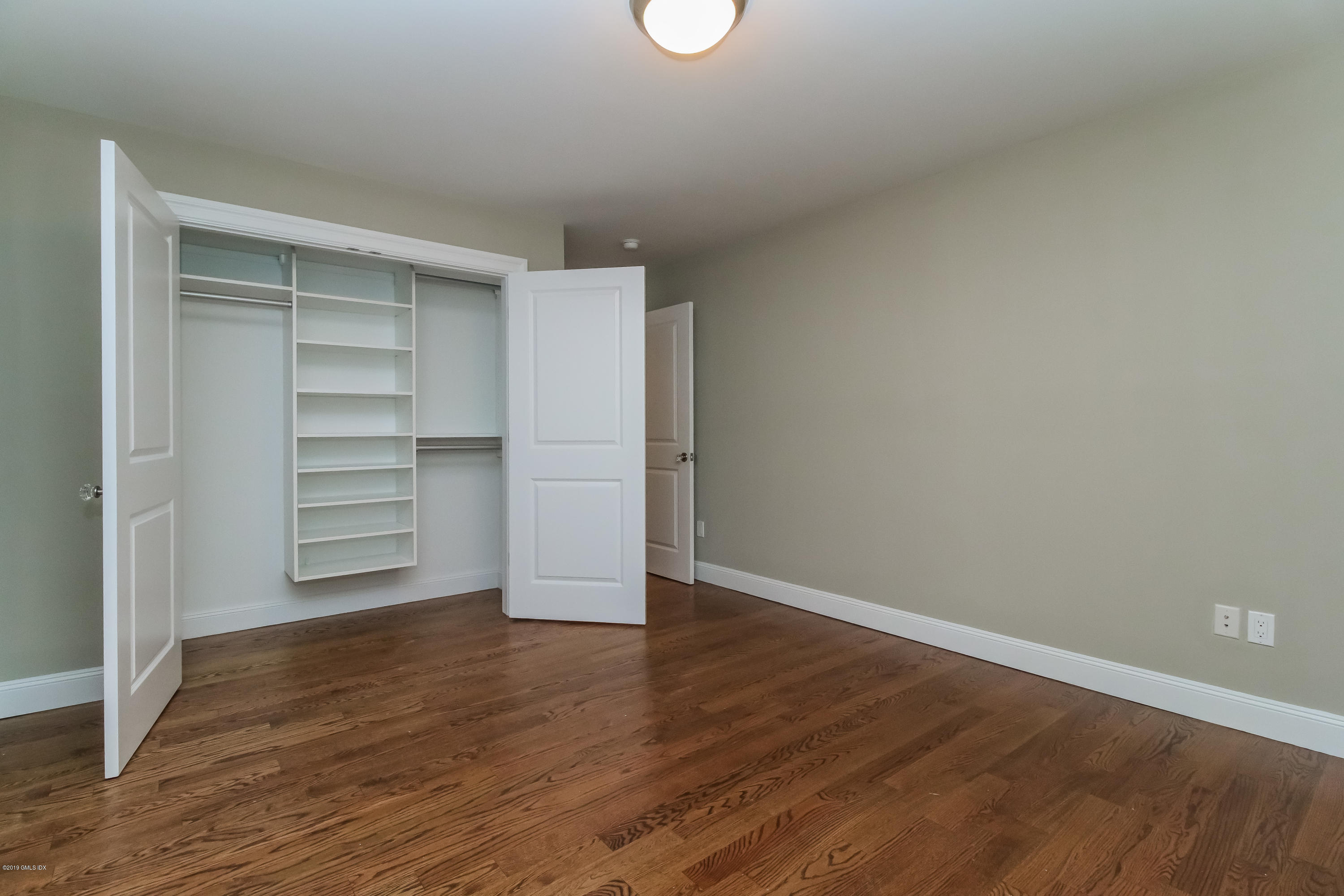 54 Dandy Drive Cos Cob, CT 06807 - Photo 25 of 35 a view of a room with an empty space and wooden floor