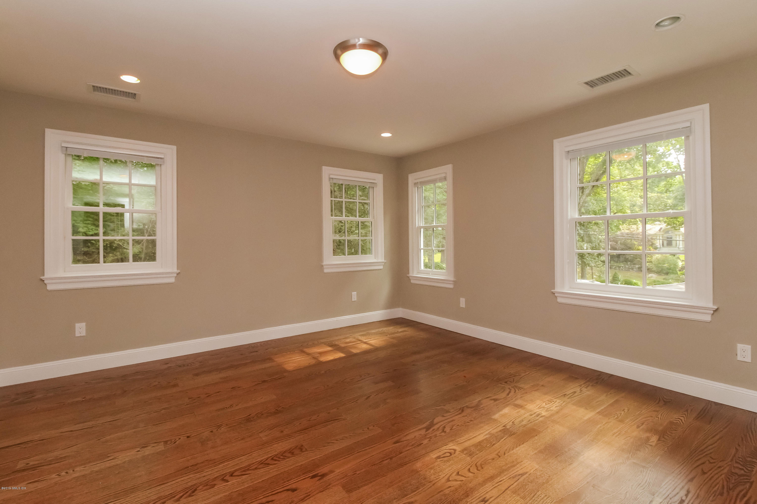 54 Dandy Drive Cos Cob, CT 06807 - Photo 27 of 35 a view of an empty room with wooden floor and a window