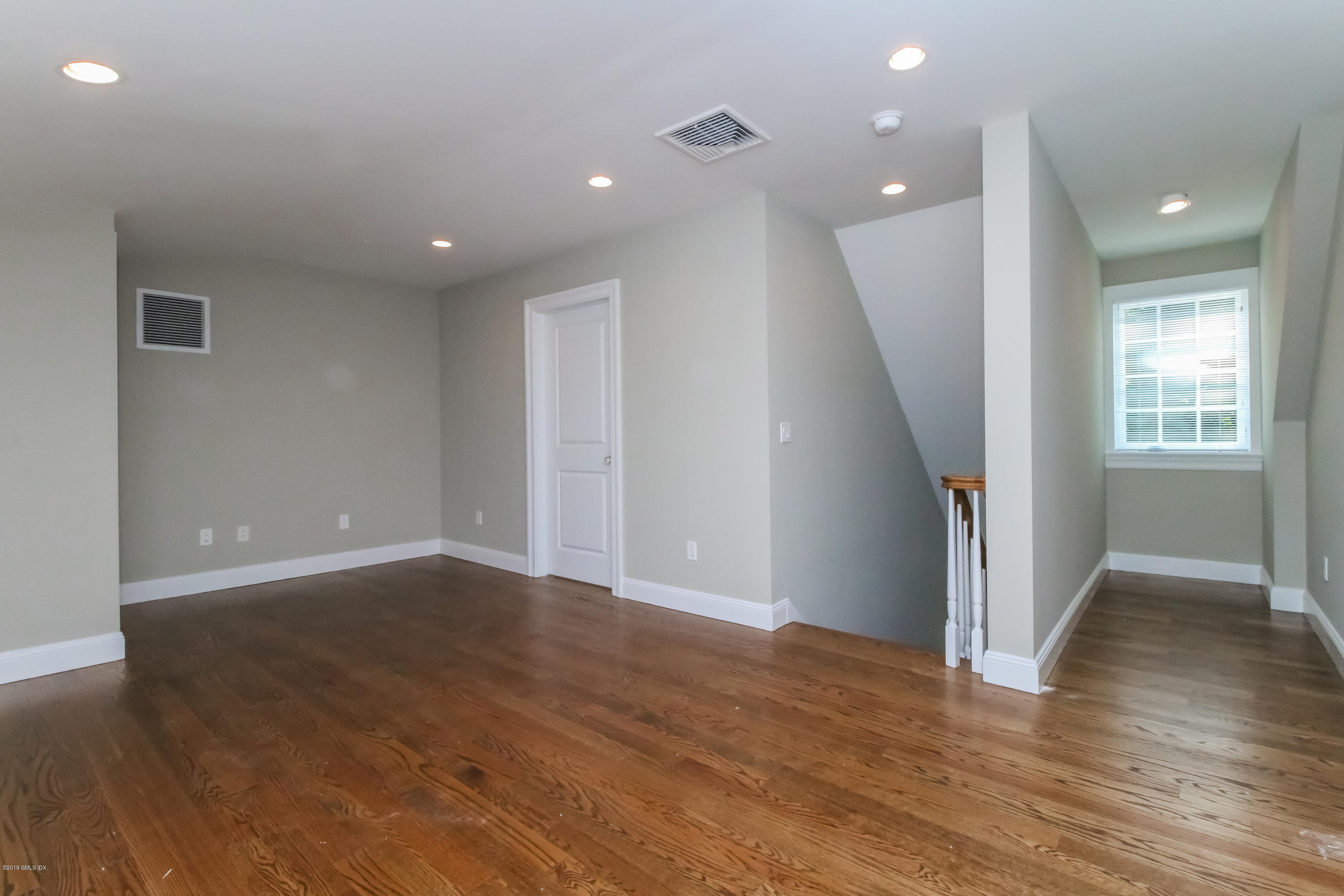 54 Dandy Drive Cos Cob, CT 06807 - Photo 30 of 35 an empty room with wooden floor and entrance