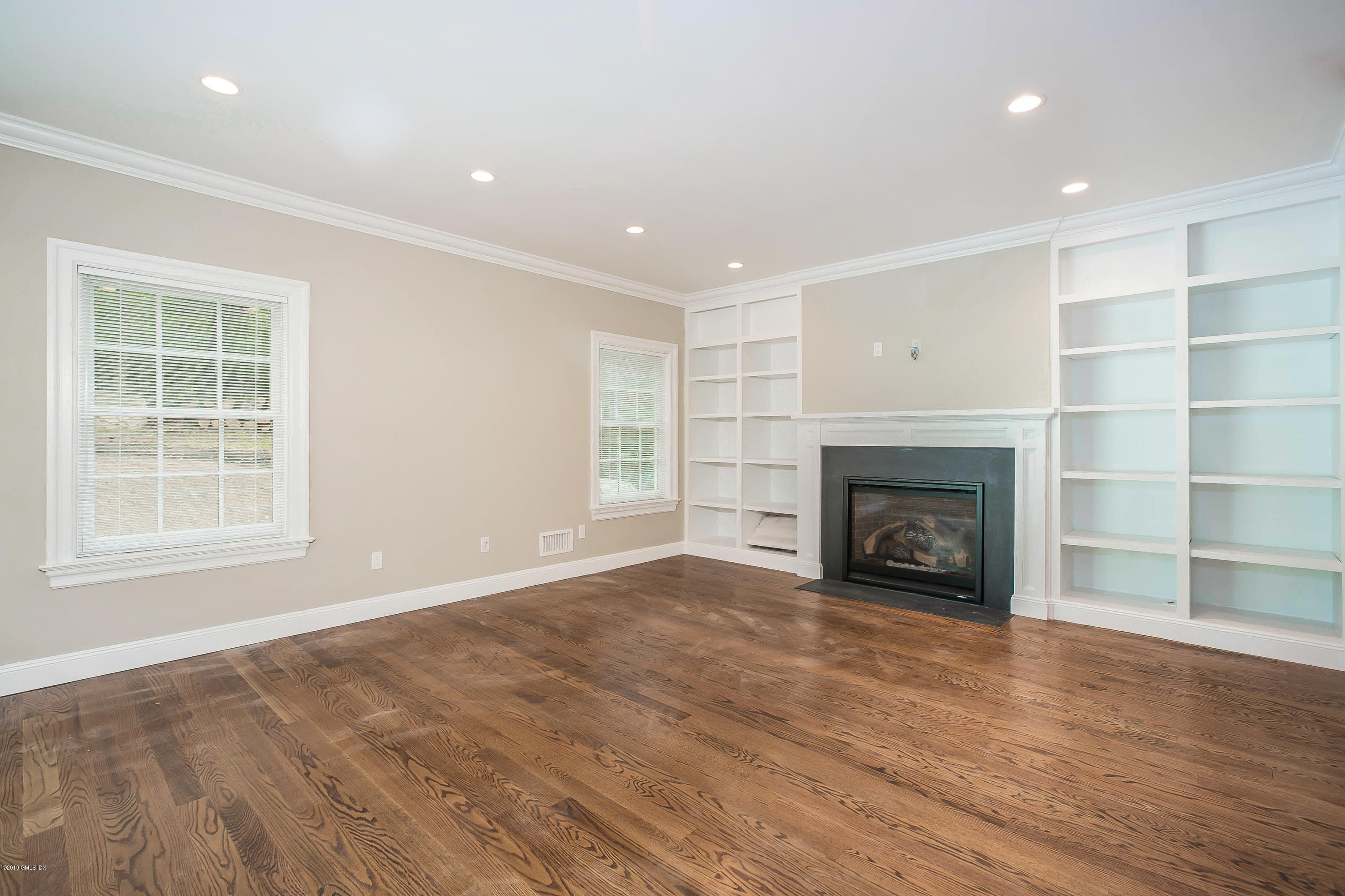 54 Dandy Drive Cos Cob, CT 06807 - Photo 8 of 35 a view of an empty room with wooden floor fireplace and a window