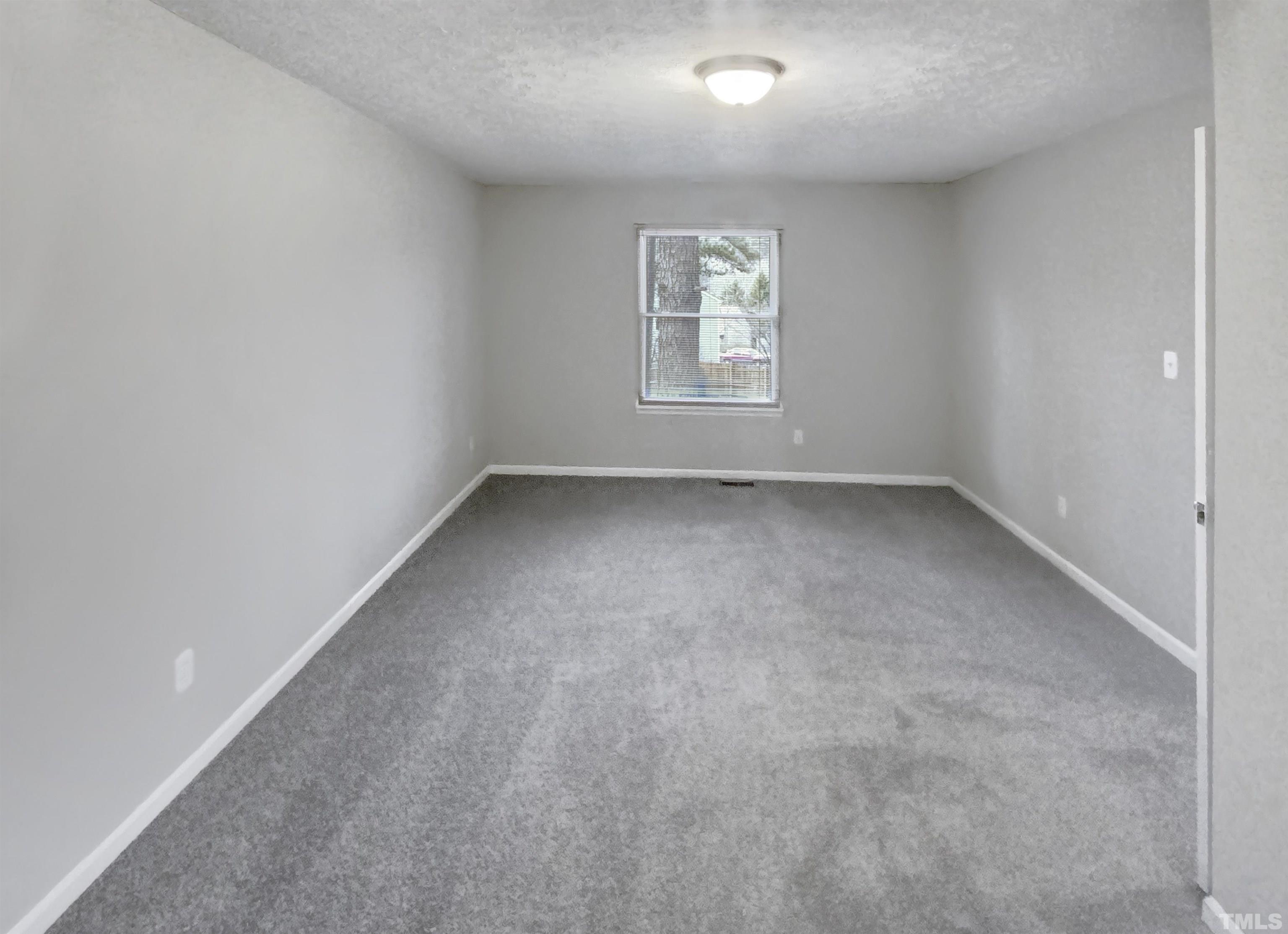 2404 Tusket Court Raleigh, NC 27613 - Photo 11 of 19 an empty room with a window
