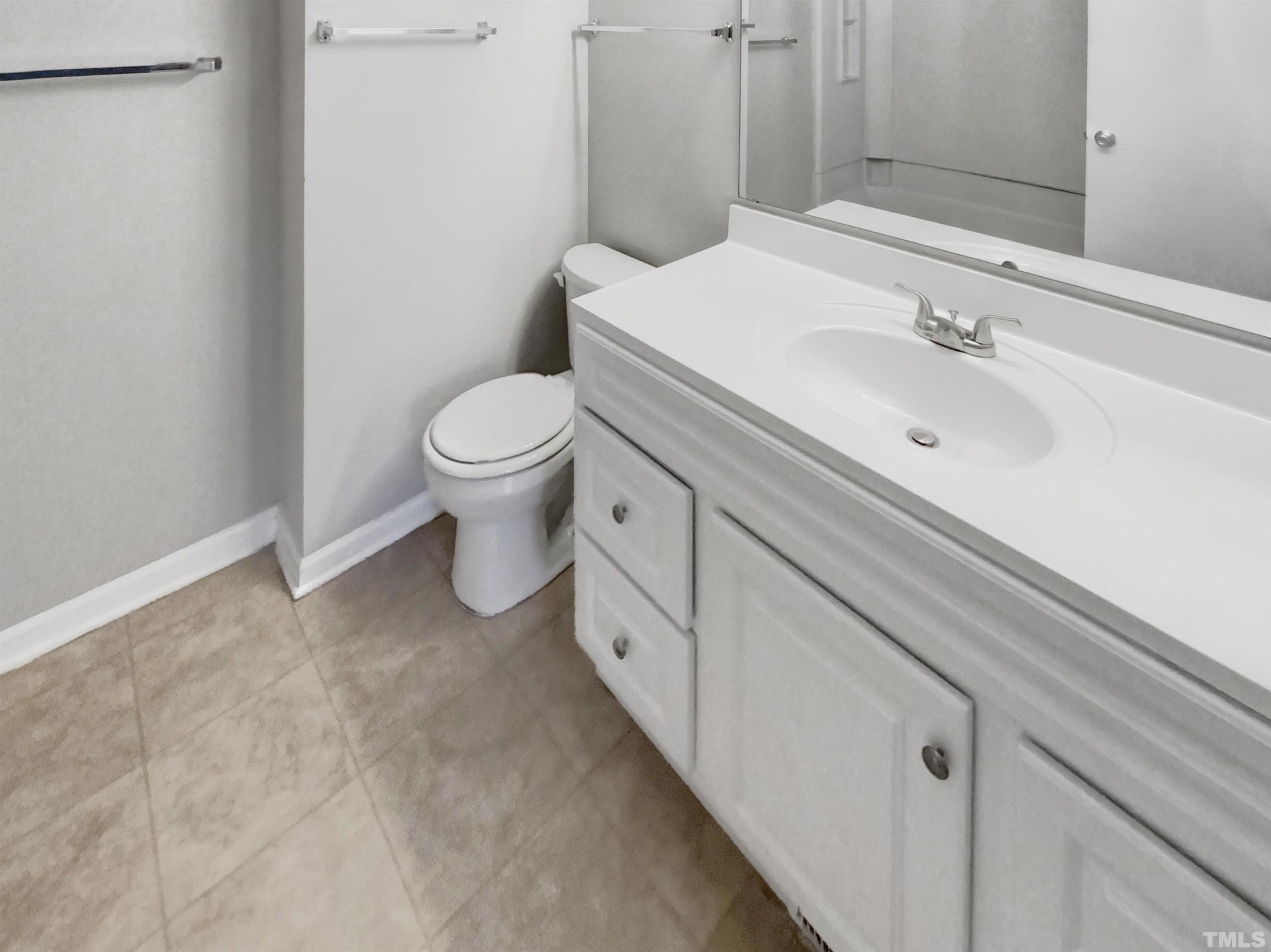 2404 Tusket Court Raleigh, NC 27613 - Photo 17 of 19 a bathroom with a sink and toilet