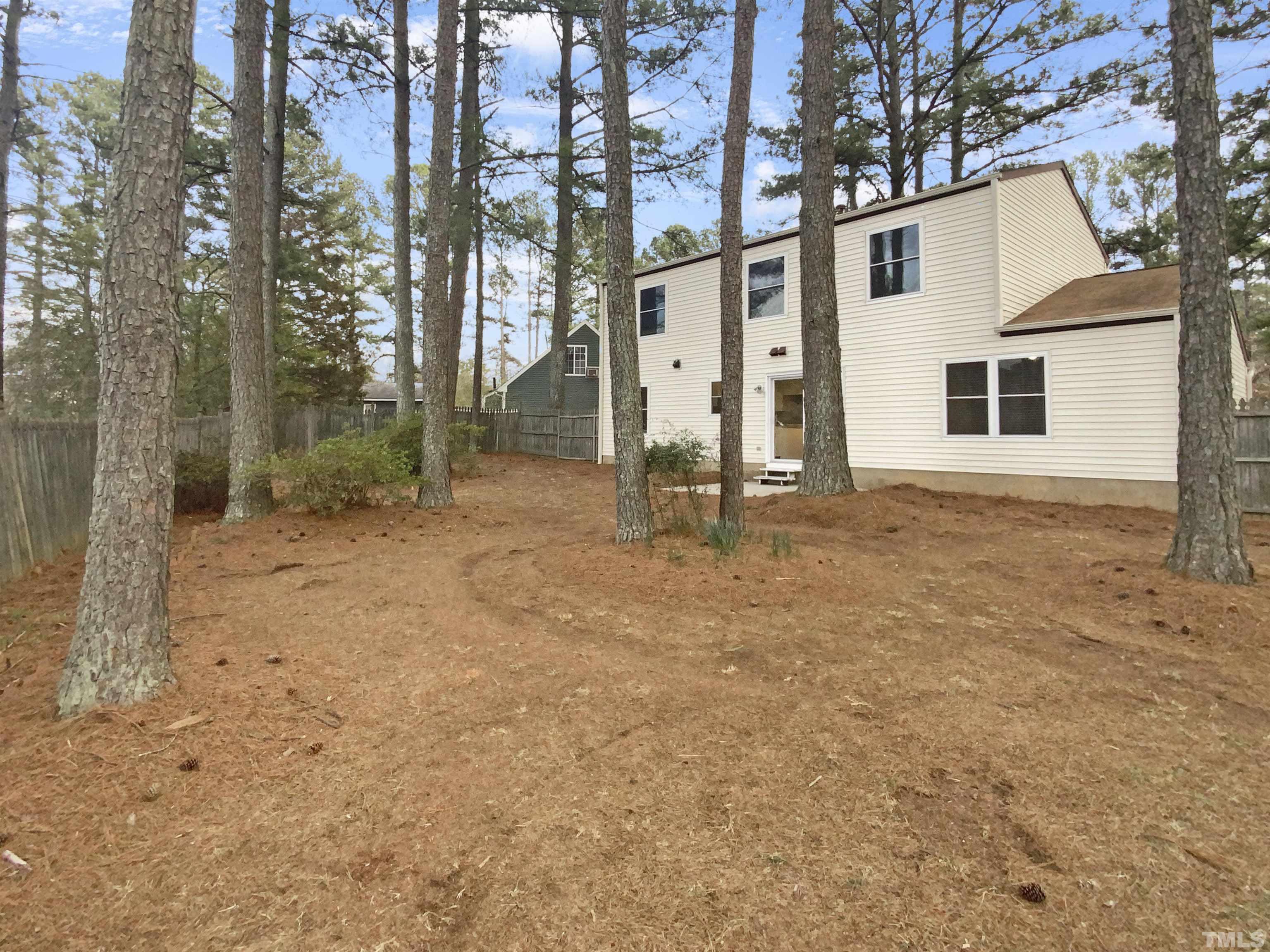 2404 Tusket Court Raleigh, NC 27613 - Photo 18 of 19 a backyard of a house with lots of green space