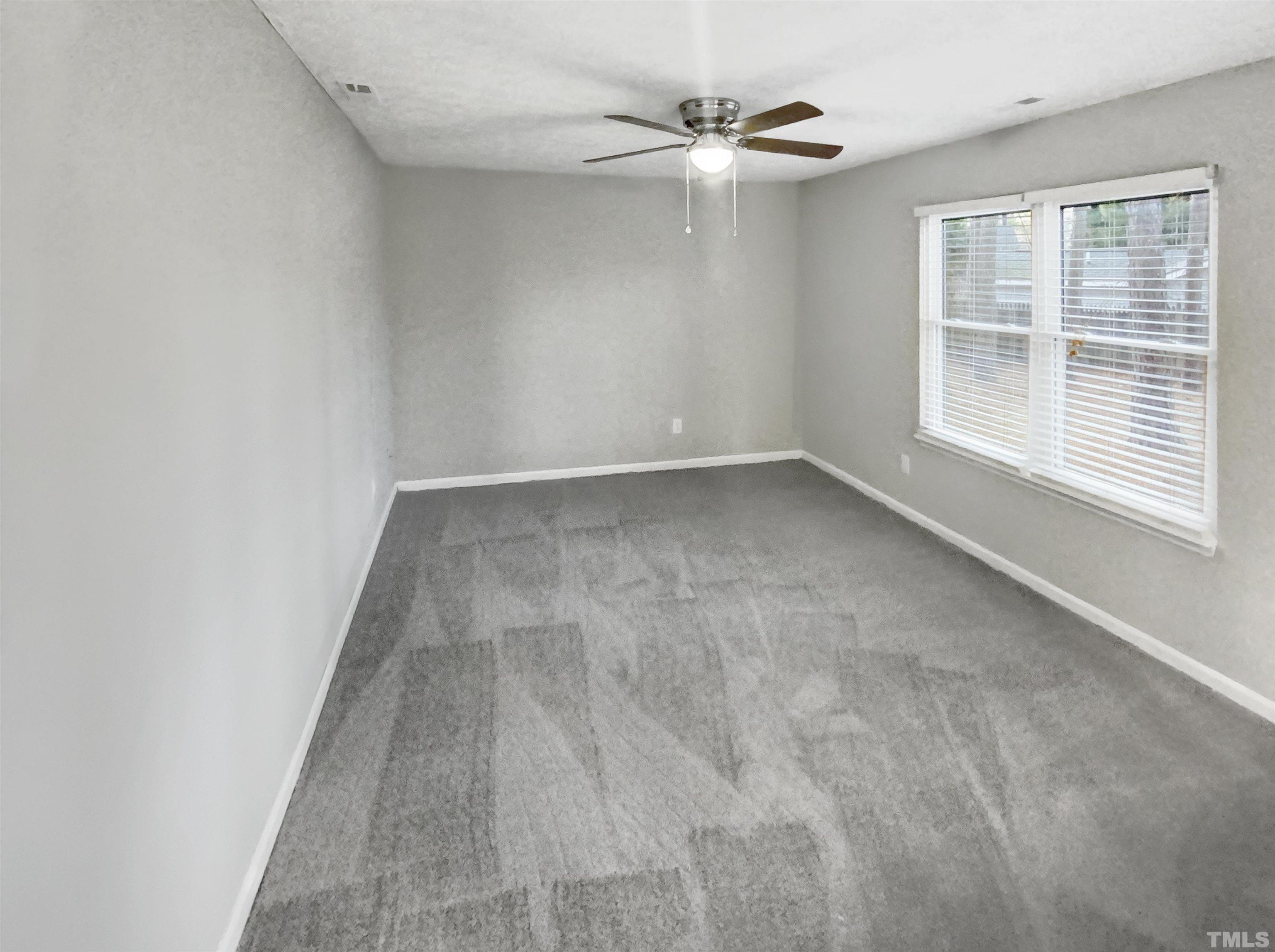 2404 Tusket Court Raleigh, NC 27613 - Photo 3 of 19 an empty room with windows and fan