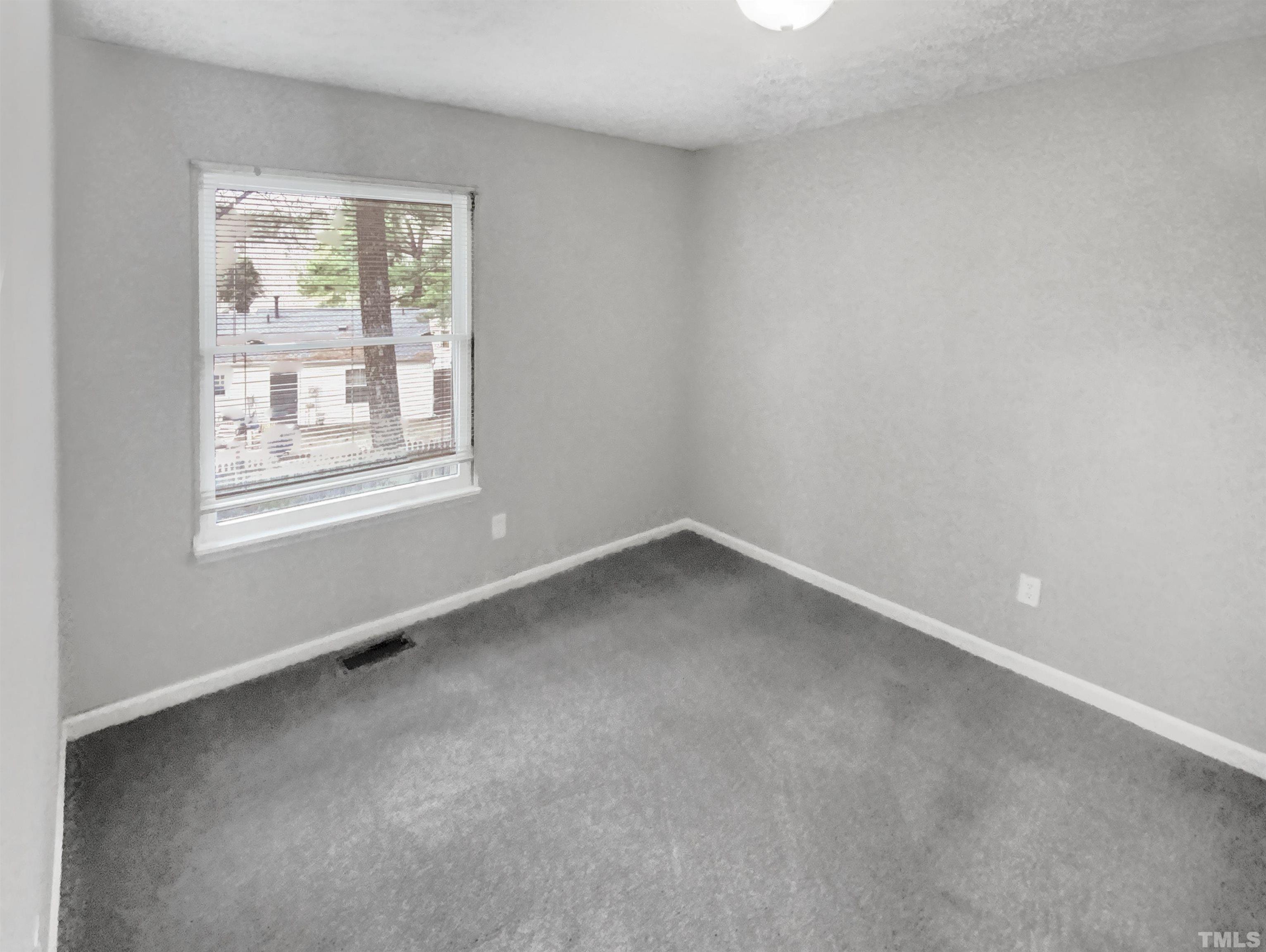 2404 Tusket Court Raleigh, NC 27613 - Photo 5 of 19 an empty room with a window