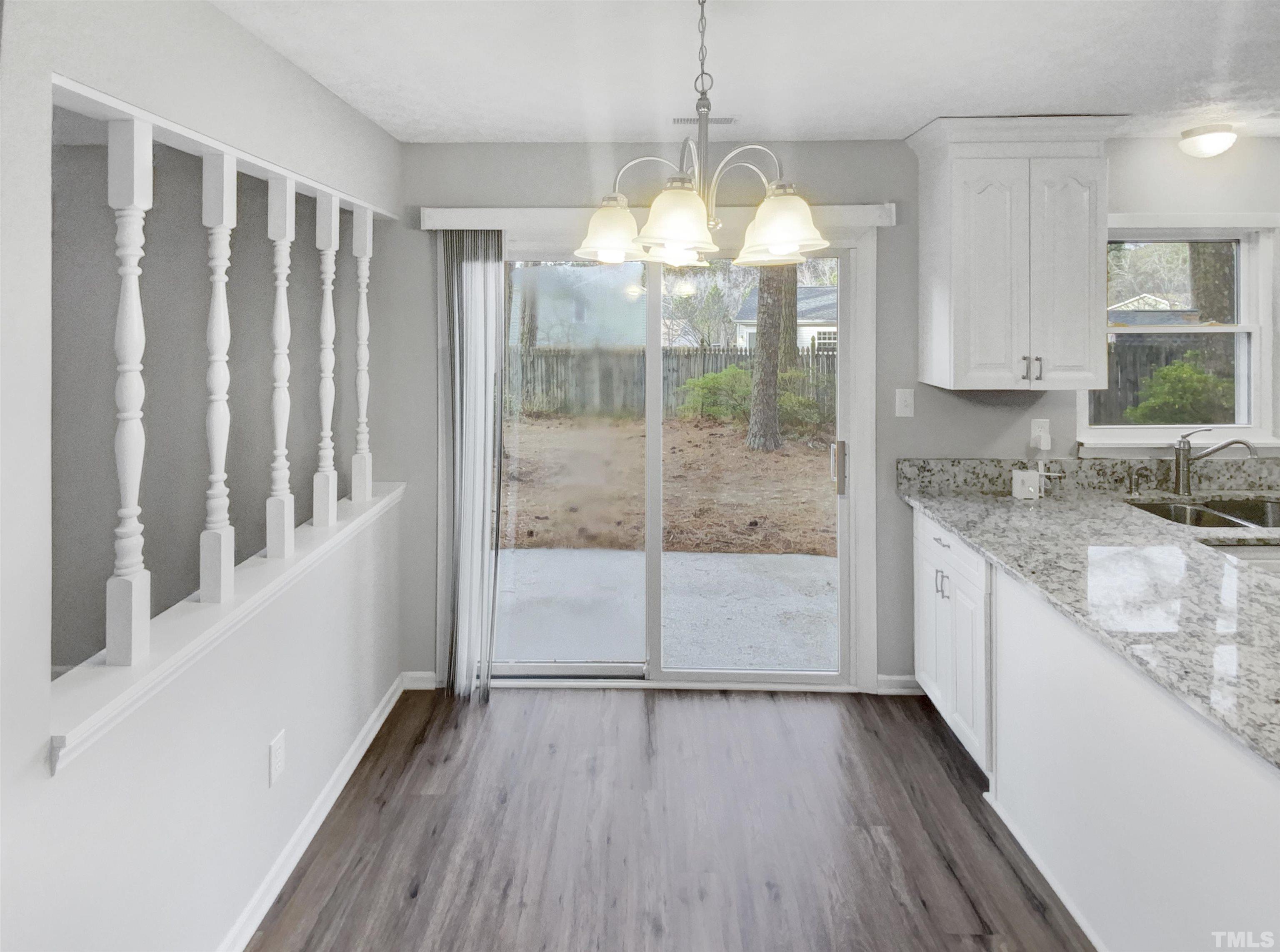 2404 Tusket Court Raleigh, NC 27613 - Photo 6 of 19 a view of a kitchen with wooden floor and electronic appliances