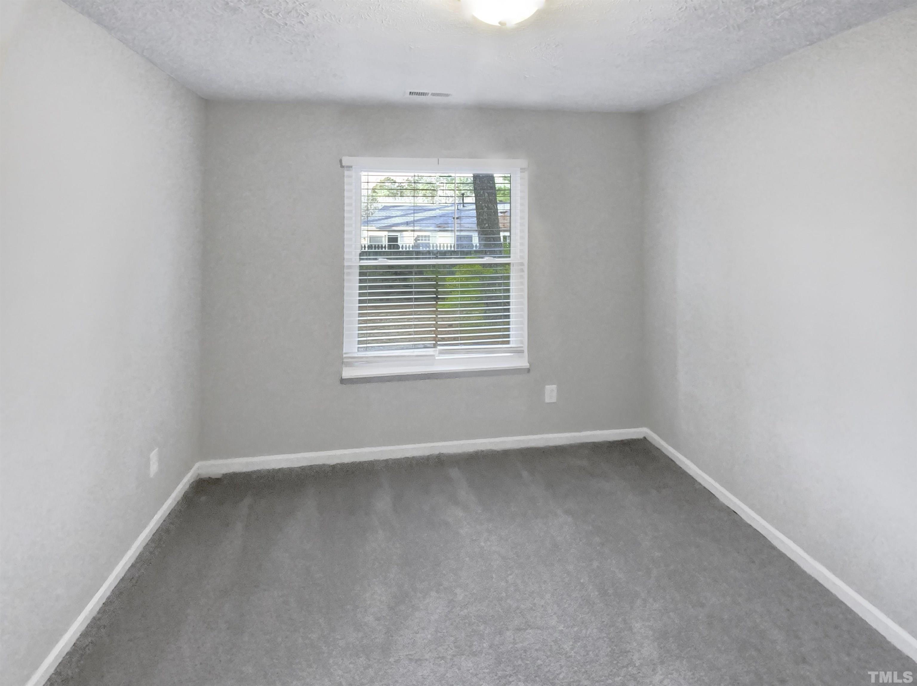 2404 Tusket Court Raleigh, NC 27613 - Photo 9 of 19 a view of an empty room with a window