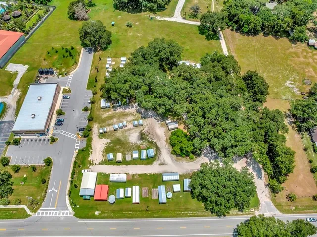 an aerial view of a houses with a yard