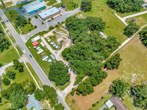 an aerial view of a house with swimming pool garden and patio