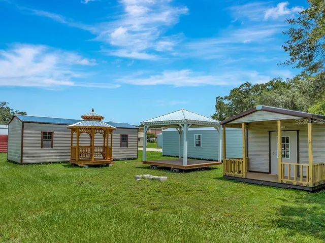 a view of a field with sitting area
