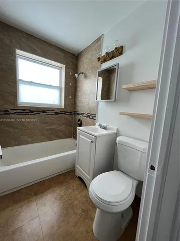 a bathroom with a toilet a sink and bathtub