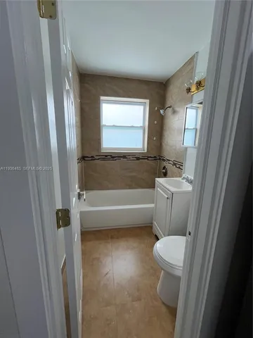 a bathroom with sink toilet and shower