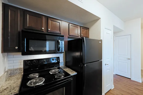 a kitchen with a refrigerator stove and microwave