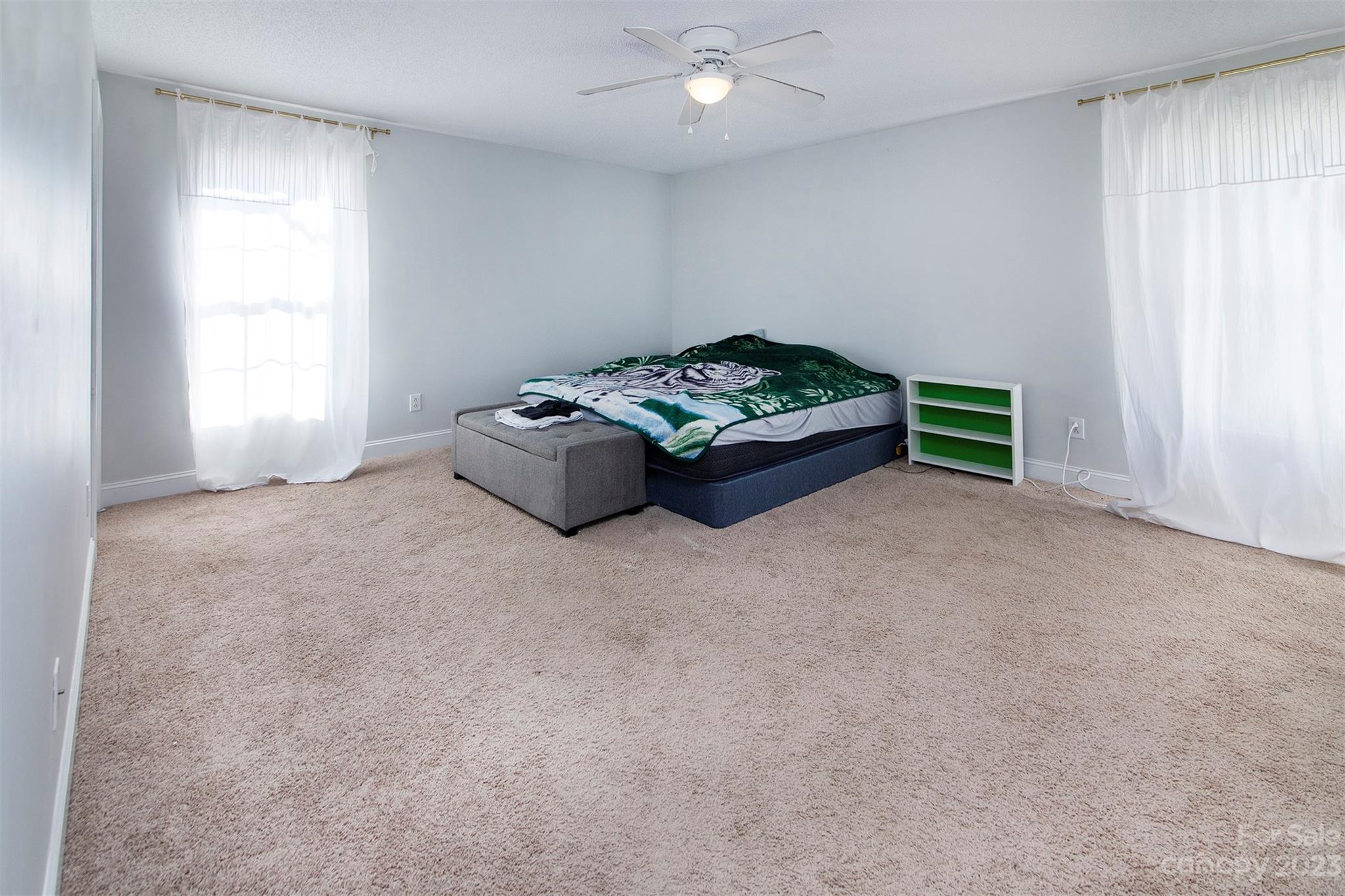210 Church Street Locust, NC 28097 - Photo 14 of 22 a spacious bedroom with a bed and a window