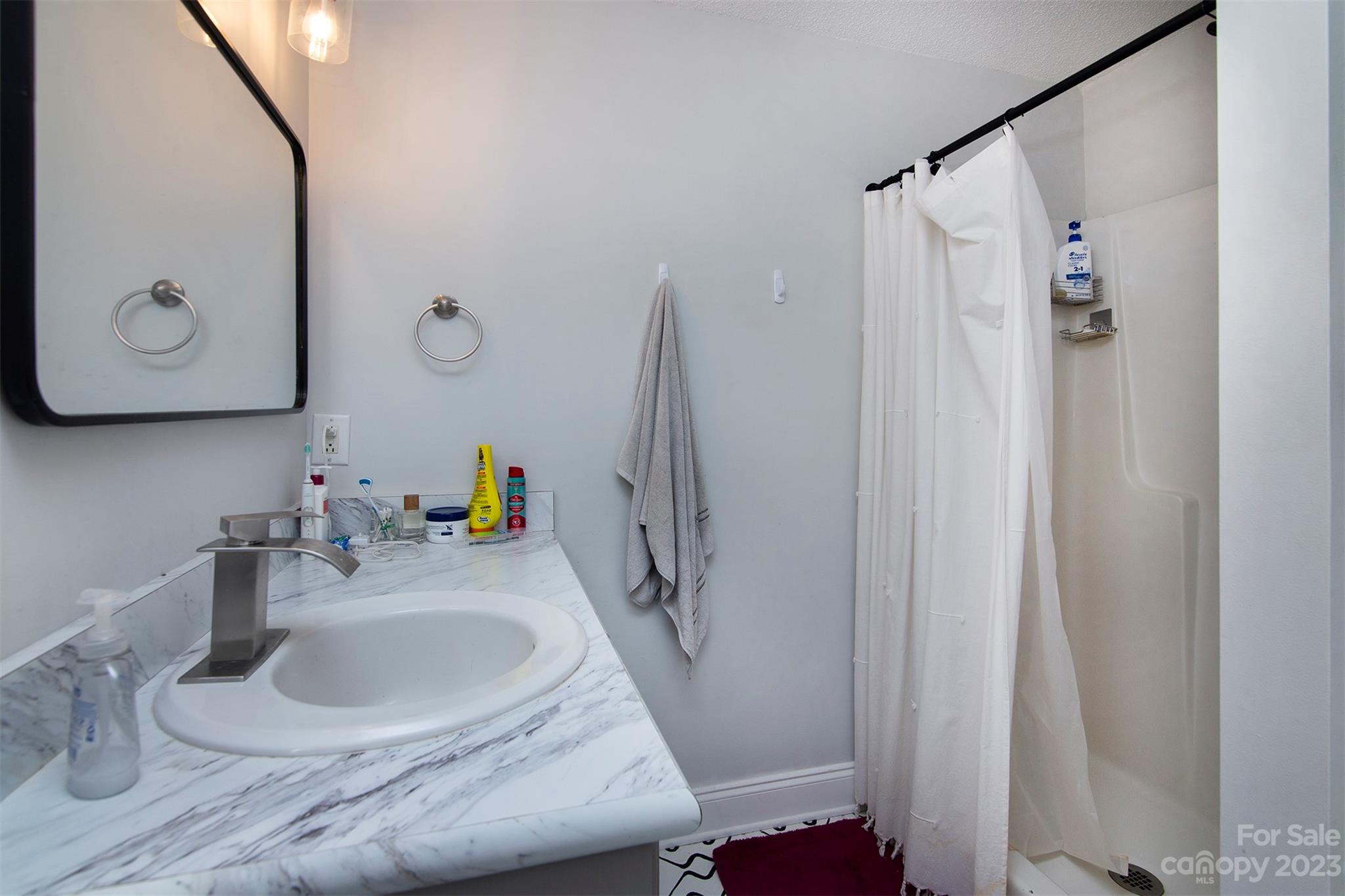 210 Church Street Locust, NC 28097 - Photo 16 of 22 a bathroom with a sink and a mirror