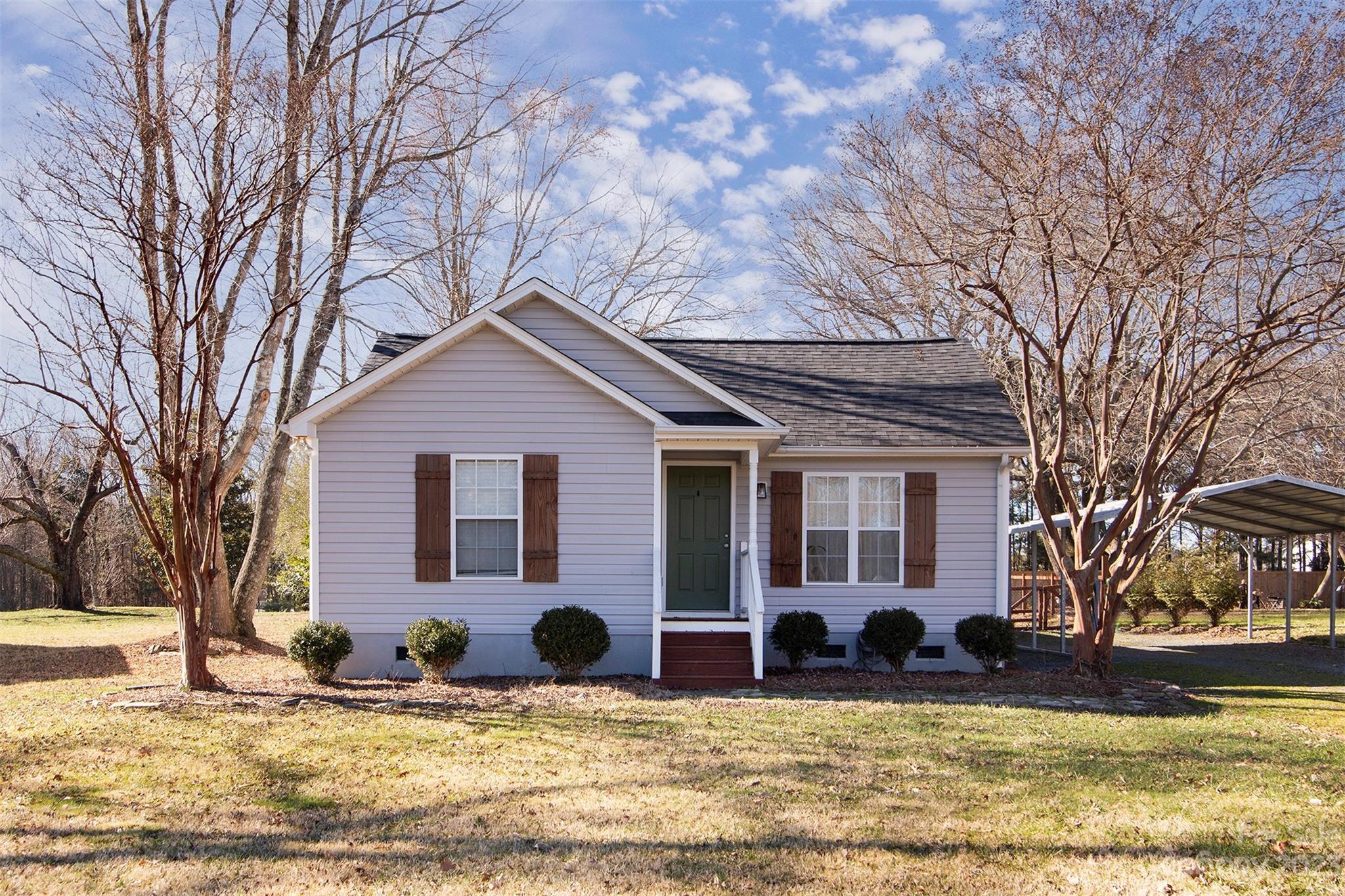 210 Church Street Locust, NC 28097 - Photo 2 of 22 a view of a house with a yard and large tree