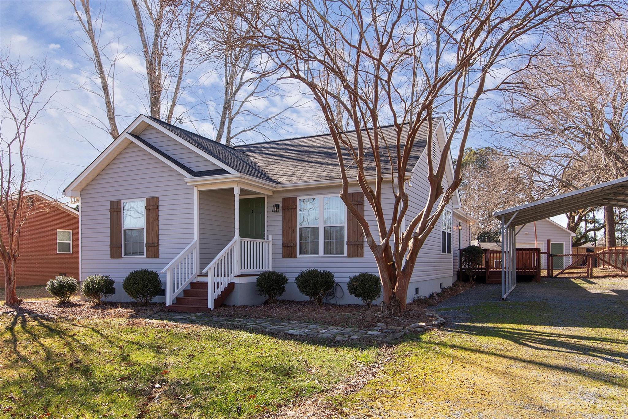 210 Church Street Locust, NC 28097 - Photo 3 of 22 a front view of a house with yard covered in snow