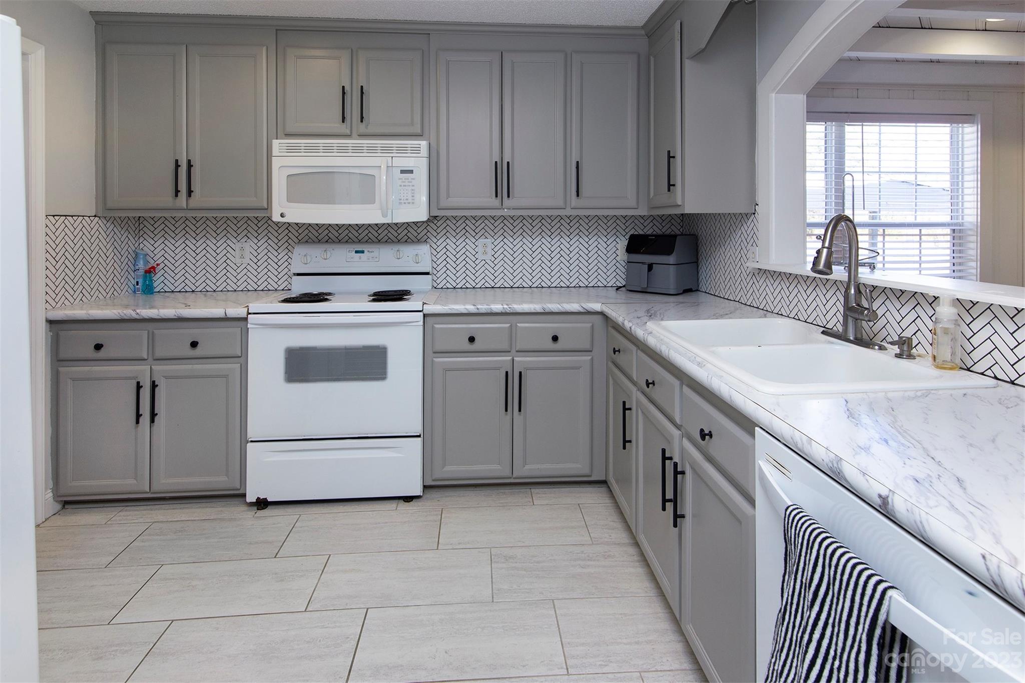 210 Church Street Locust, NC 28097 - Photo 7 of 22 a kitchen with cabinets appliances and a window