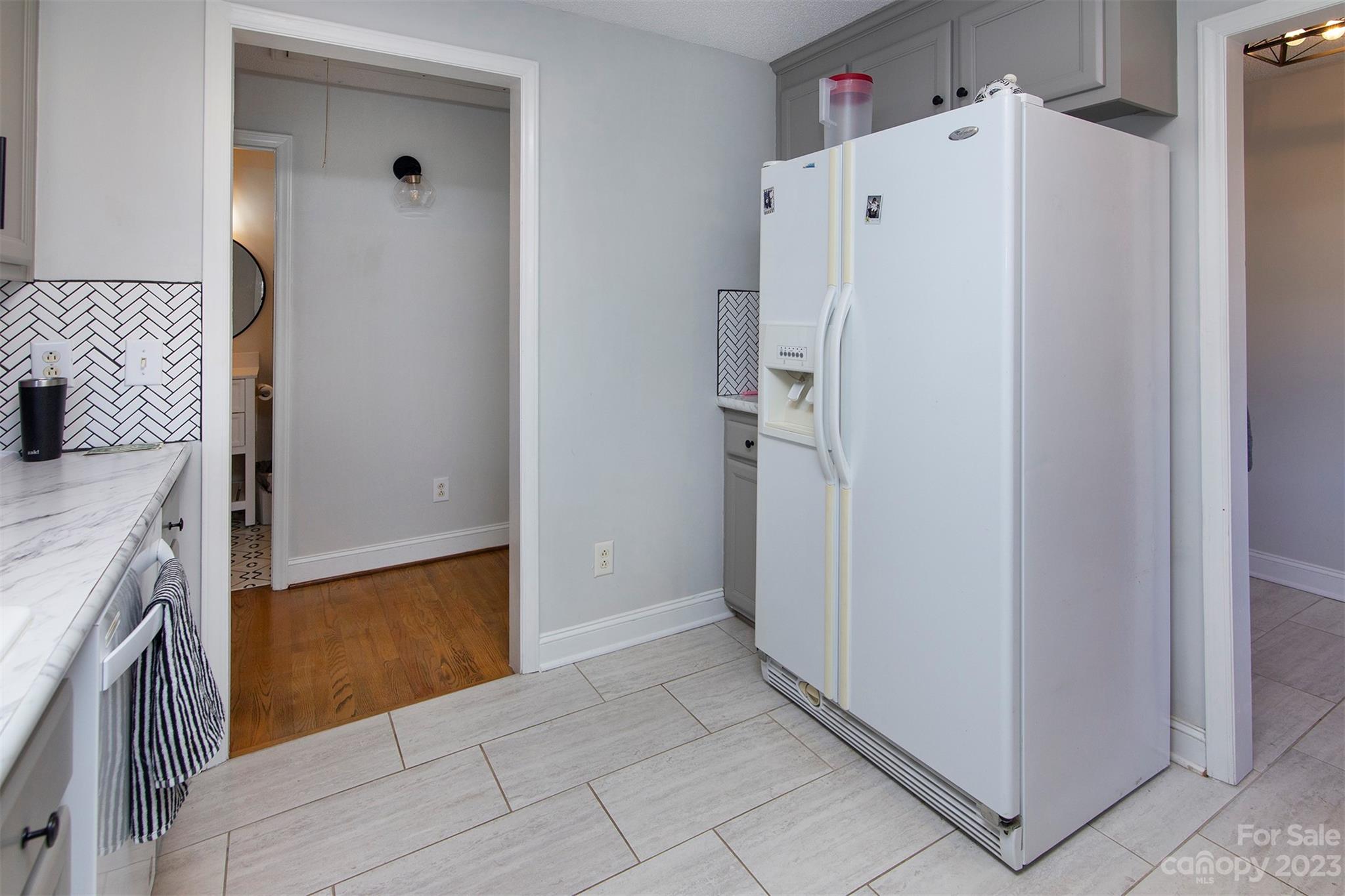 210 Church Street Locust, NC 28097 - Photo 8 of 22 a white refrigerator freezer and a stove sitting inside of a kitchen