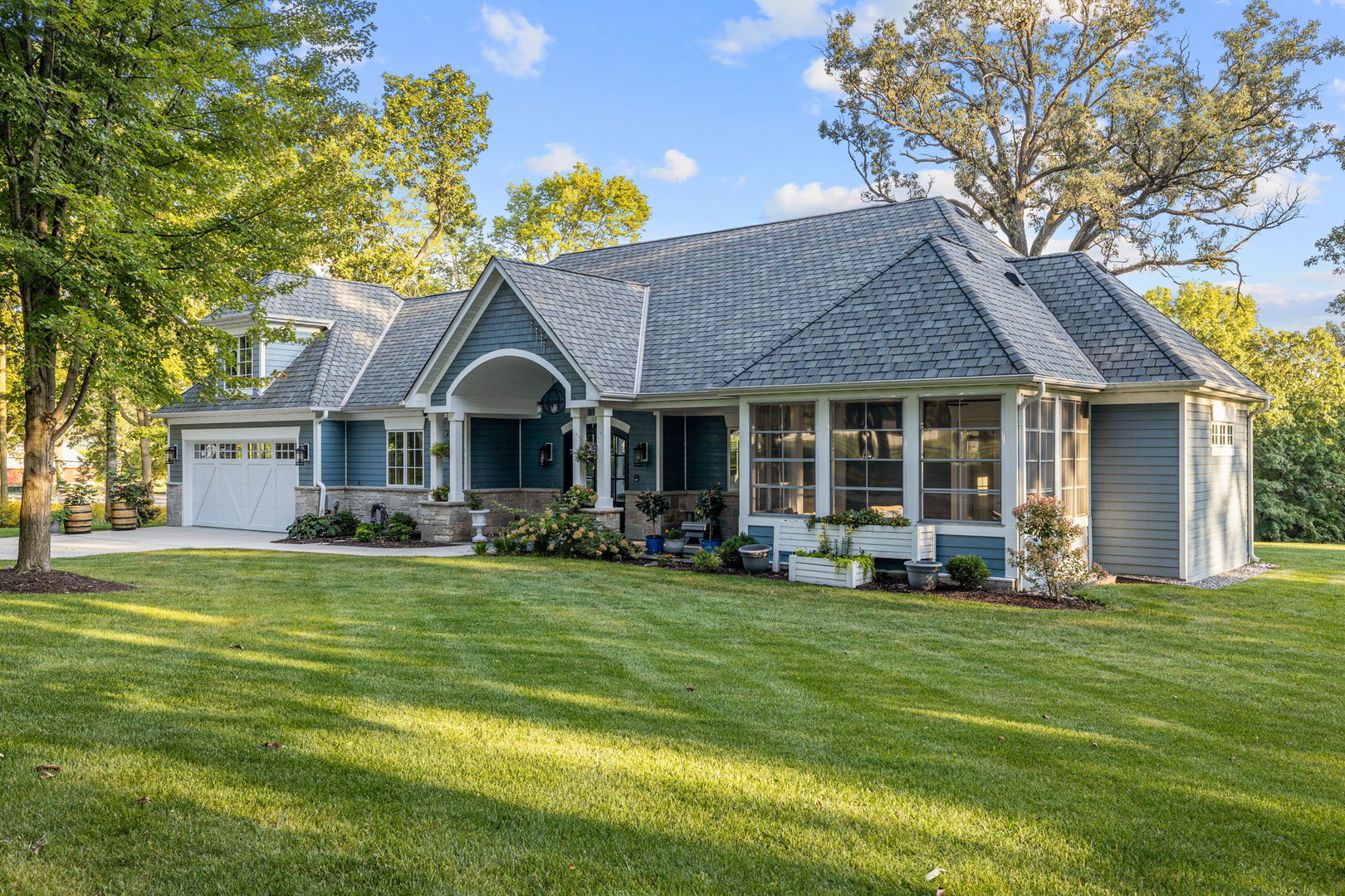 5021 Minkler Road Yorkville, IL 60560 - Photo 9 of 92 a front view of a house with a garden and trees