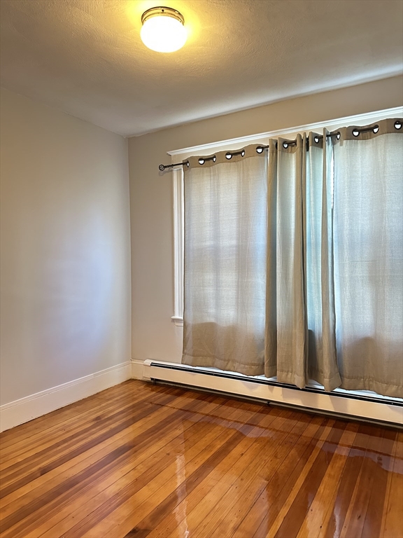 41 Flynt Street, Unit 1F Quincy, MA 02171 - Photo 16 of 21 a view of a room with wooden floor and large window