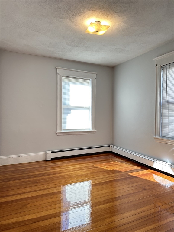 41 Flynt Street, Unit 1F Quincy, MA 02171 - Photo 17 of 21 a view of a room with wooden floor and windows