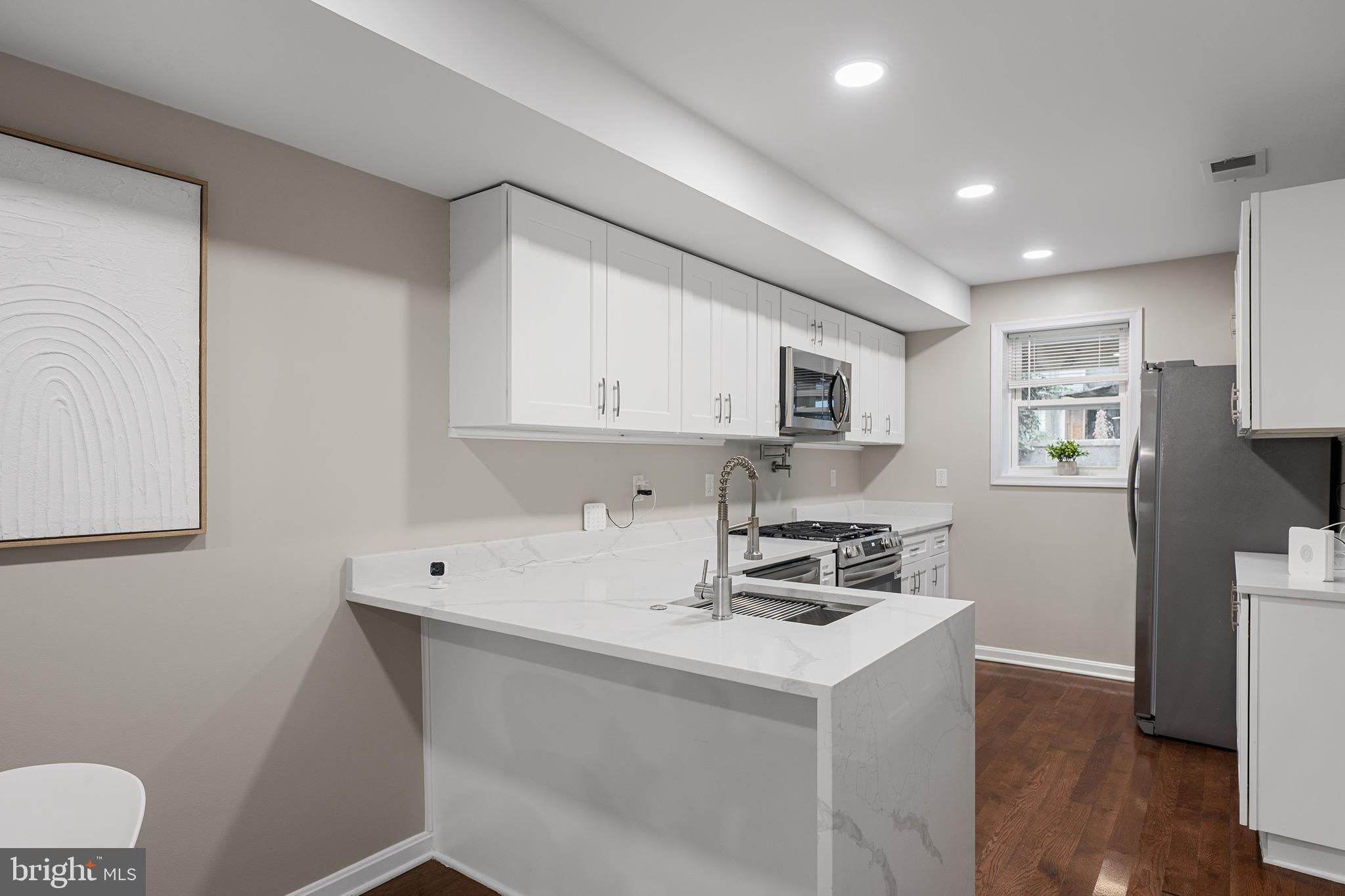 1358 Towson Street Baltimore, MD 21230 - Photo 11 of 39 a kitchen with cabinets a sink and appliances