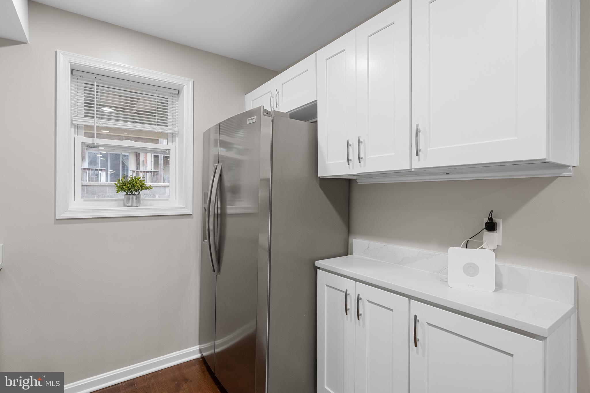 1358 Towson Street Baltimore, MD 21230 - Photo 13 of 39 a kitchen with stainless steel appliances white cabinets and a refrigerator