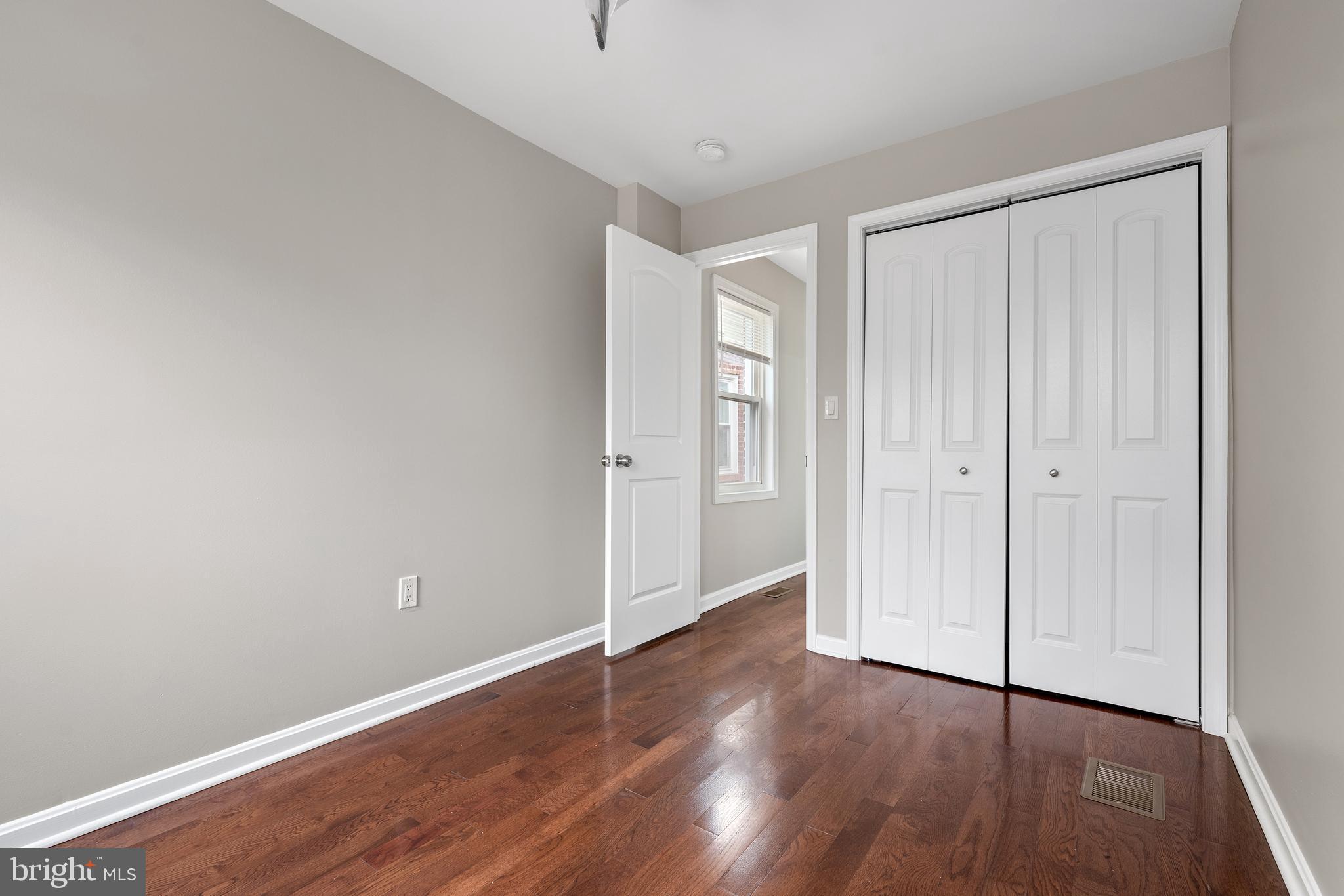 1358 Towson Street Baltimore, MD 21230 - Photo 26 of 39 a view of an empty room with wooden floor