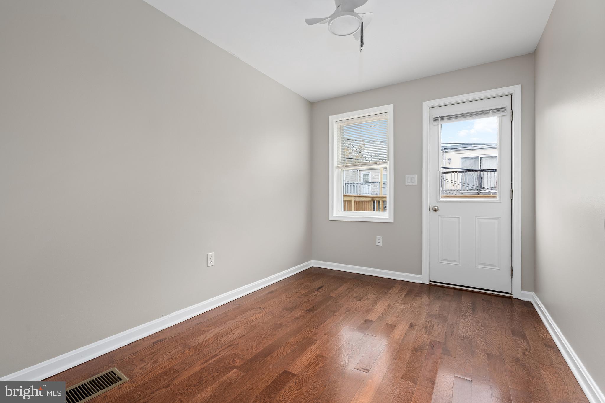 1358 Towson Street Baltimore, MD 21230 - Photo 27 of 39 wooden floor in an empty room with a window