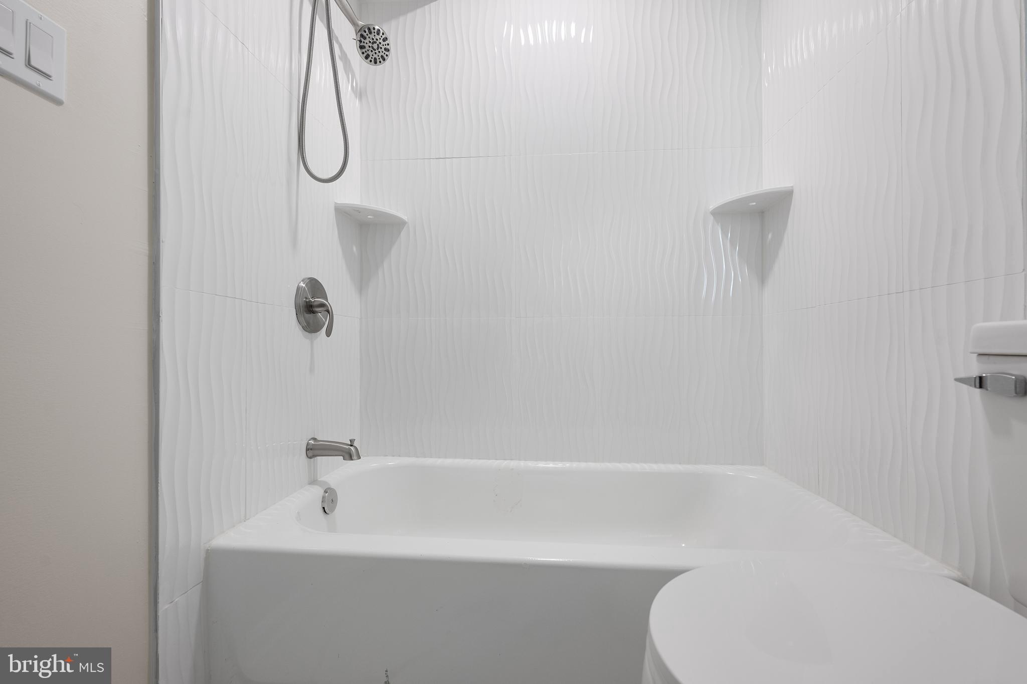 1358 Towson Street Baltimore, MD 21230 - Photo 28 of 39 a bathroom with a shower a toilet and a shower