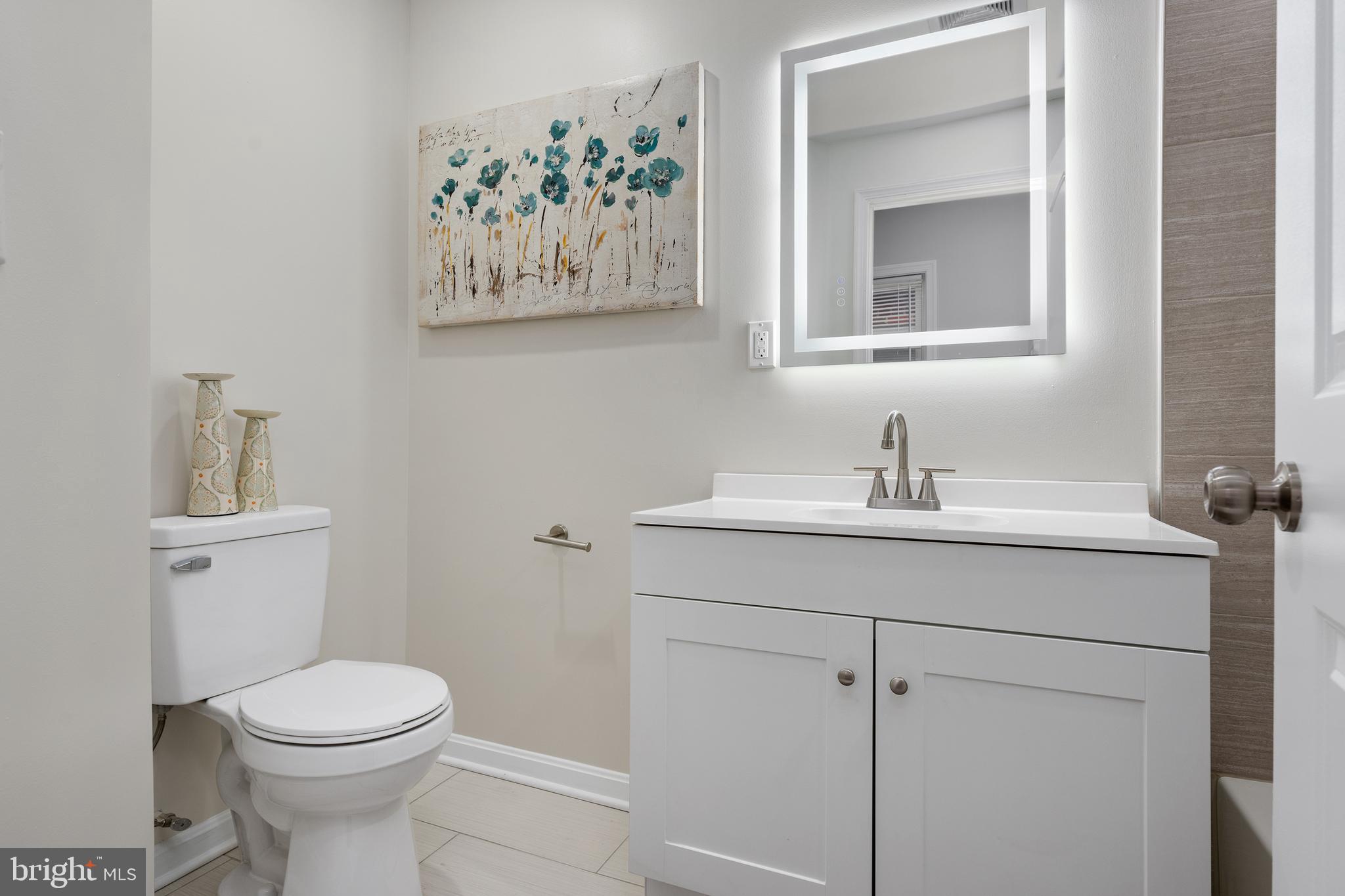 1358 Towson Street Baltimore, MD 21230 - Photo 30 of 39 a bathroom with a toilet sink and mirror