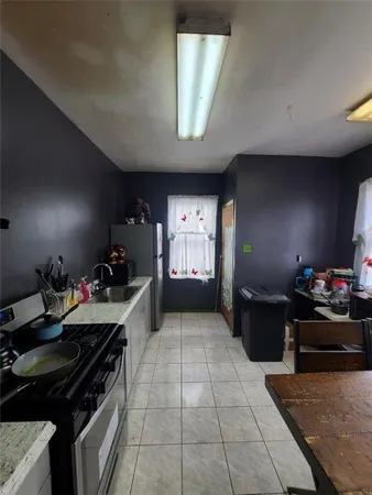 a kitchen with a stove and a refrigerator