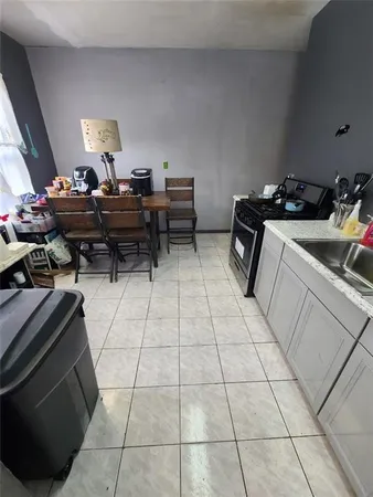 a kitchen with a sink and a stove top oven