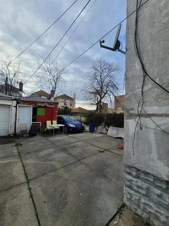 a view of a car park in front of a house