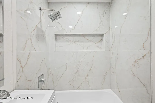 a bathroom with a bathtub and shower