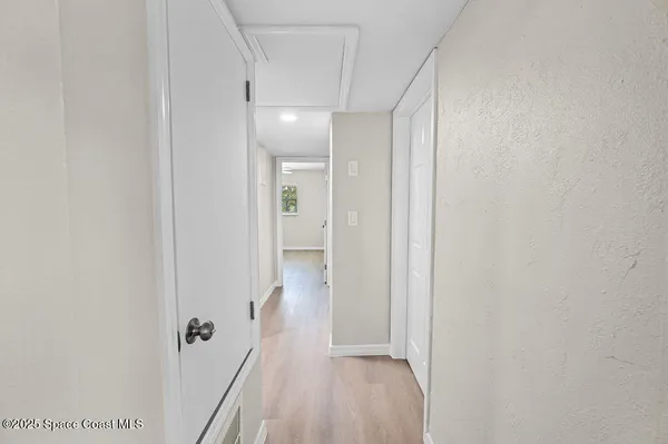 a view of a hallway with a room