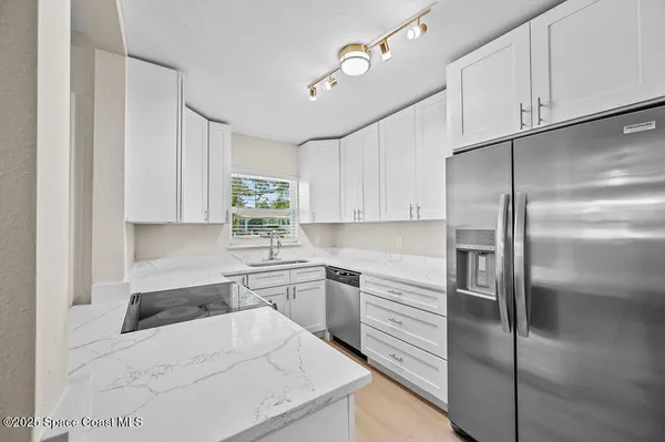 a kitchen with a refrigerator and a sink