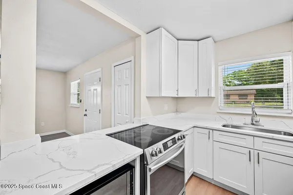 a kitchen with a sink cabinets and window